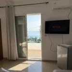 Bright balcony door opening to a beautiful Ionian Sea view from our Lukovë triple accommodation.