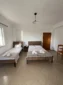 Spacious layout of the Triple Room with Sea View featuring a double and single bed with fresh towels.