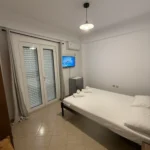 Air-conditioned budget double room featuring a flat-screen TV and mini-fridge in Lukovë.