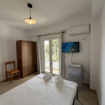 Bright budget double accommodation with glass doors opening to the outside patio area.