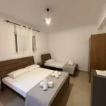 Clean and comfortable Budget Triple Room featuring a double and single bed at Kolagji Rooms in Lukovë.