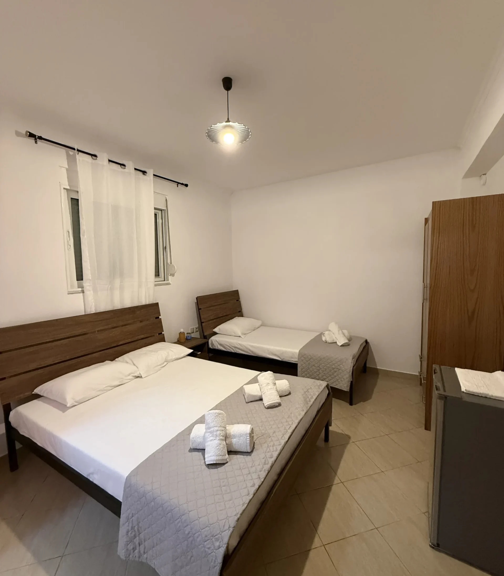 Clean and comfortable Budget Triple Room featuring a double and single bed at Kolagji Rooms in Lukovë.