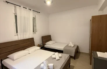 Home 3 Clean and comfortable Budget Triple Room featuring a double and single bed at Kolagji Rooms in Lukovë.