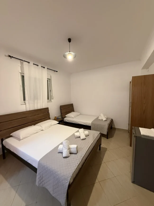 Clean and comfortable Budget Triple Room featuring a double and single bed at Kolagji Rooms in Lukovë.