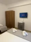 Air conditioning, flat-screen TV, and room amenities inside the Lukovë budget triple accommodation.