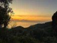 Panoramic view of a golden sunset over the Ionian Sea viewed from the olive groves of Lukovë.
