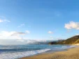 Panoramic view of the sandy coastline and coastal mountains at Shpella Beach on the Albanian Riviera.