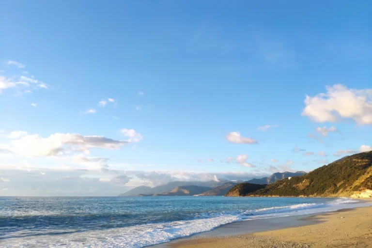 Panoramic view of the sandy coastline and coastal mountains at Shpella Beach on the Albanian Riviera.