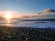 Low angle shot of smooth beach stones glowing during a beautiful golden sunset on the Albanian Riviera.