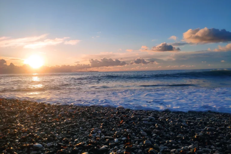 Low angle shot of smooth beach stones glowing during a beautiful golden sunset on the Albanian Riviera.