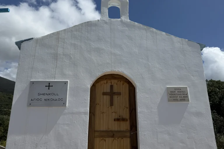 The historic white Shenkoll church located near the coast of Shpella Beach in Lukovë.