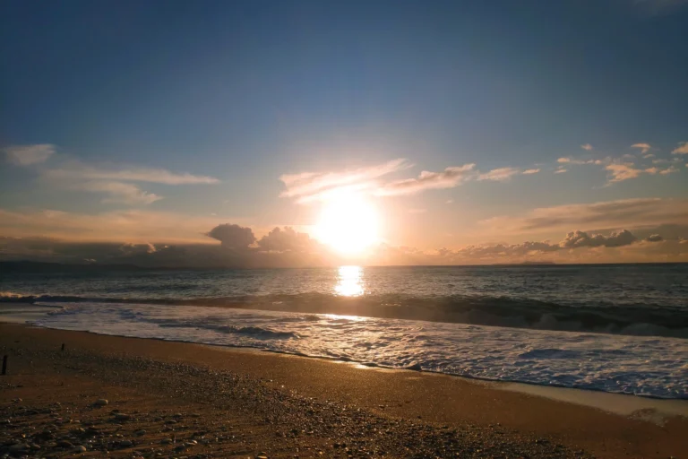 Golden sunset reflecting over the ocean waves at the peaceful Shpella Beach in Lukovë.