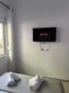 Wall-mounted TV with Netflix above the bed in the Triple Room with Outdoor View at Kolagji Rooms.