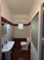 Private en-suite bathroom with red tiles and a modern shower in the Triple Room with Outdoor View.
