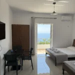 Comfortable double and single bed in our bright sea view triple accommodation on the Albanian Riviera.